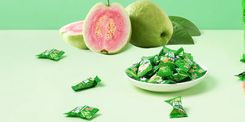 Bag of Hongyuan guava candy with cut guava and a dish of wrapped pieces